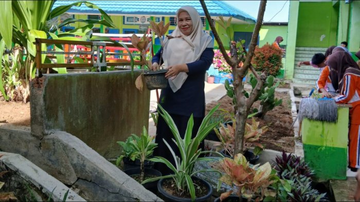 kegiatan penanaman Tanaman Obat Keluarga (TOGA) yang melibatkan guru serta siswa/i di lingkungan madrasah.